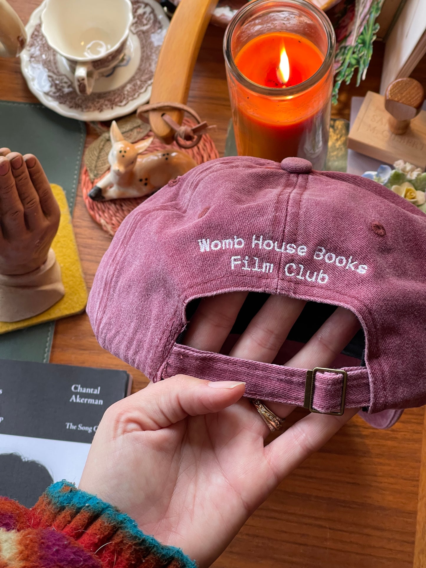 The film is the text Womb House Books Hat