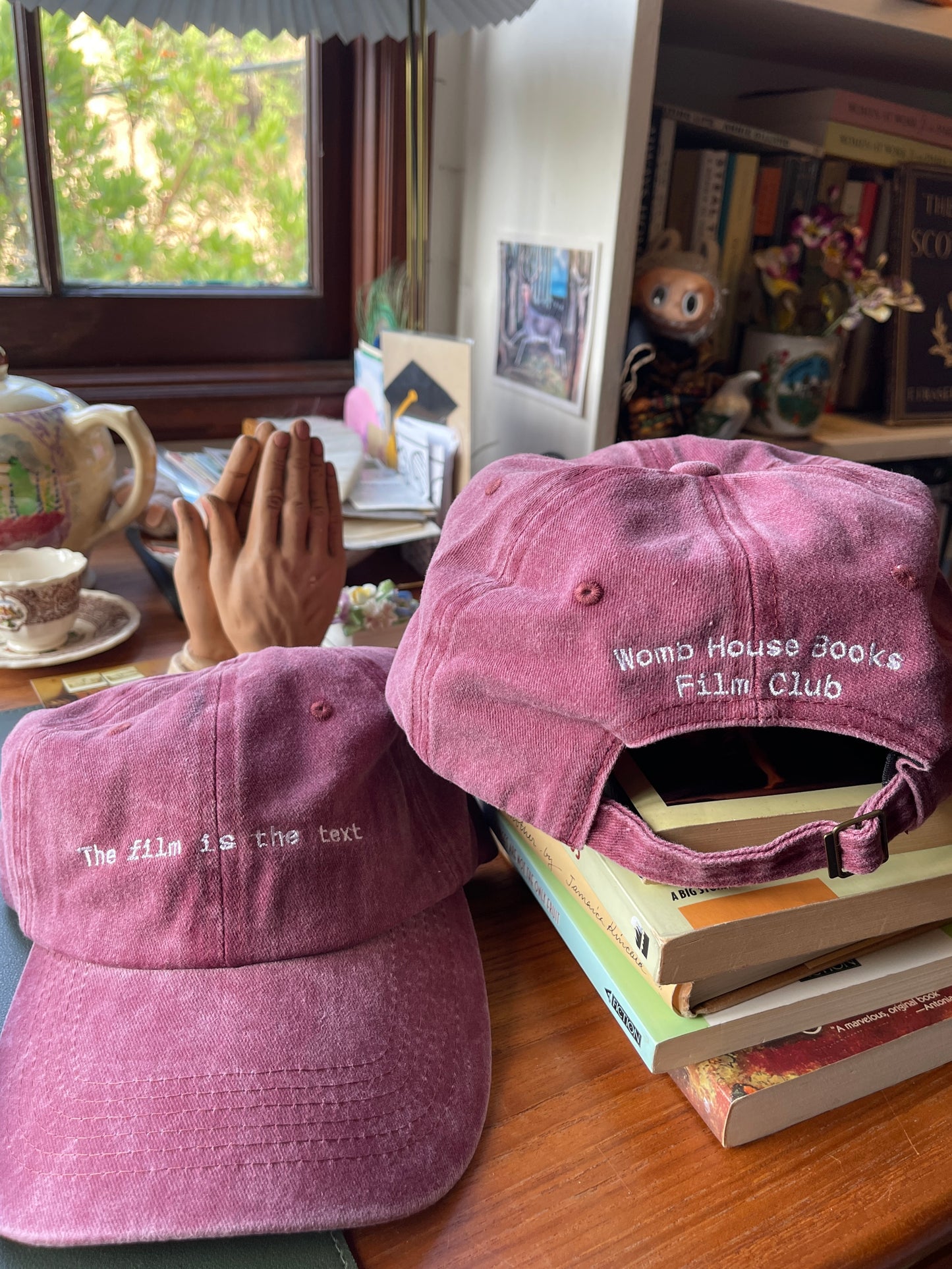 The film is the text Womb House Books Hat