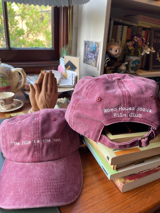 The film is the text Womb House Books Hat