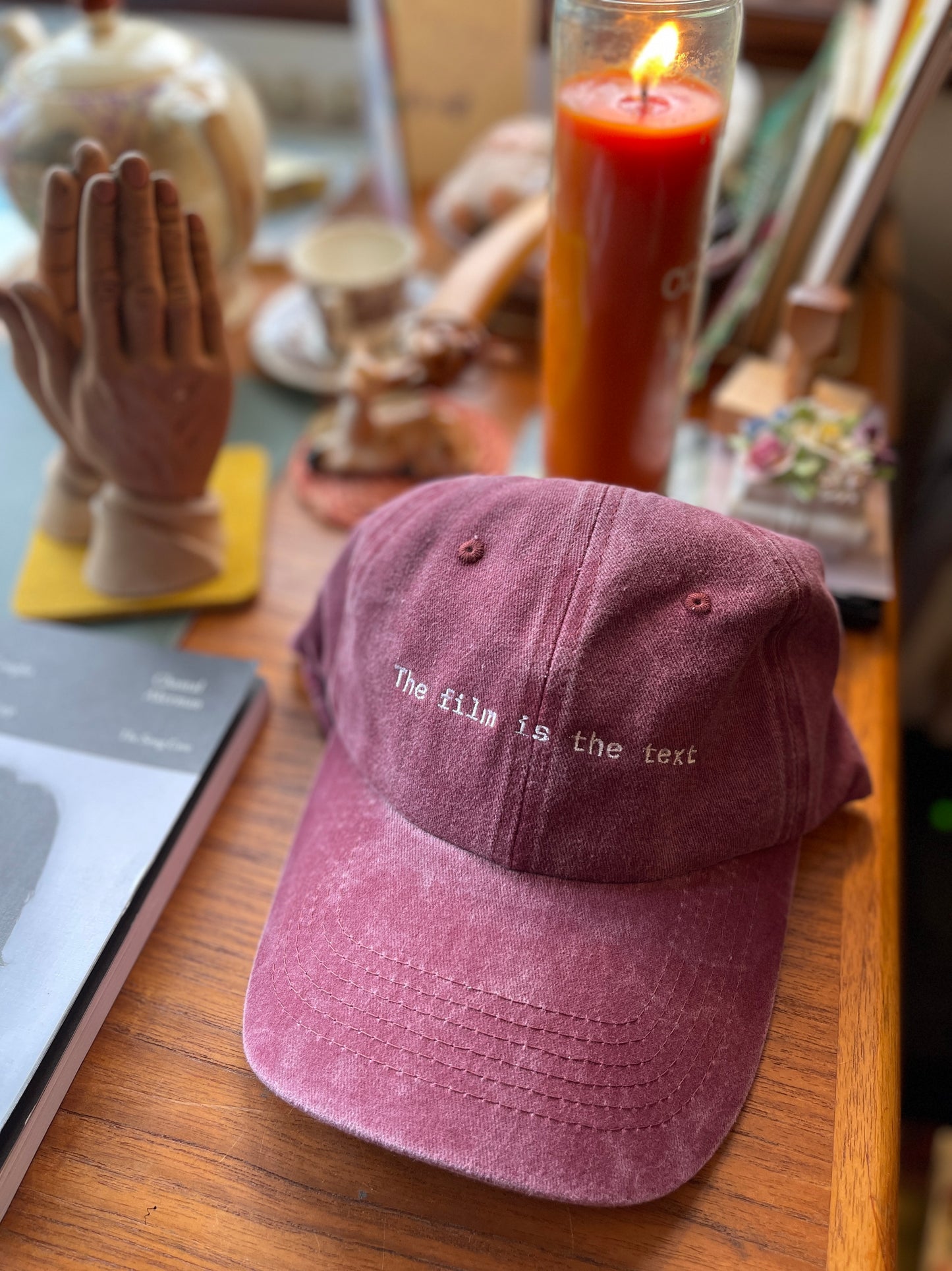 The film is the text Womb House Books Hat
